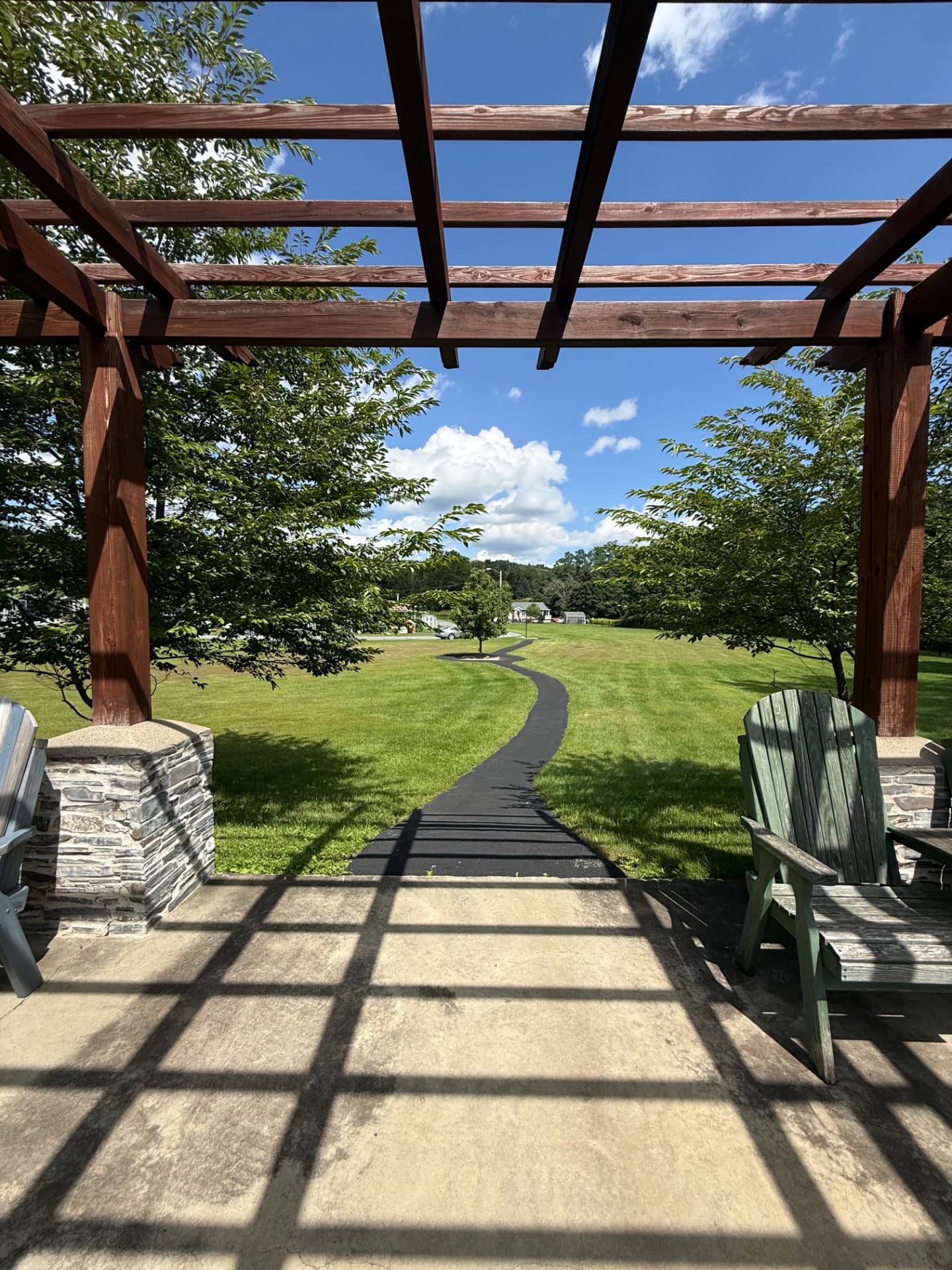 The view out across the open lawn from beneath the pergola