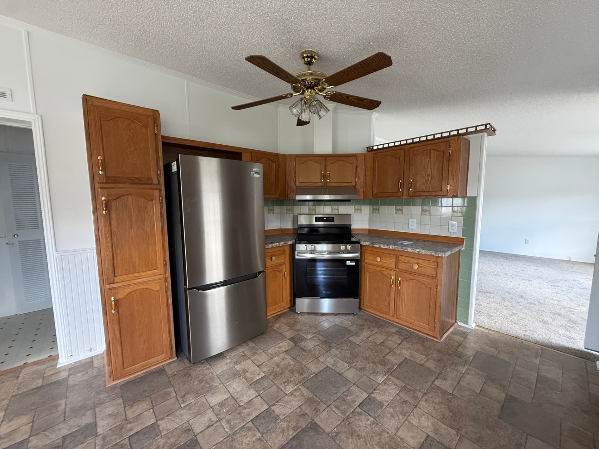 Kitchen at 40 Michael with stainless appliances and oak cabinetry