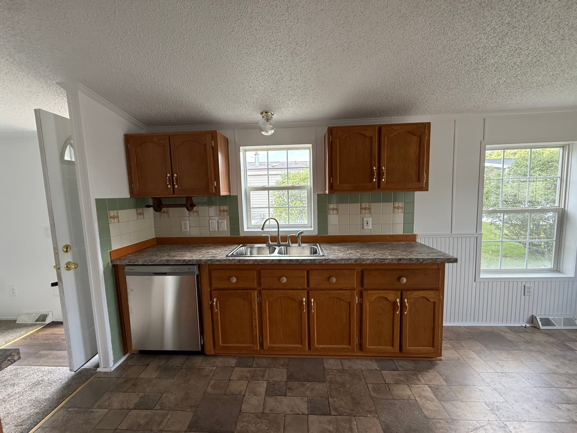 Kitchen counter and sink at 40 Michael with windows over the yard