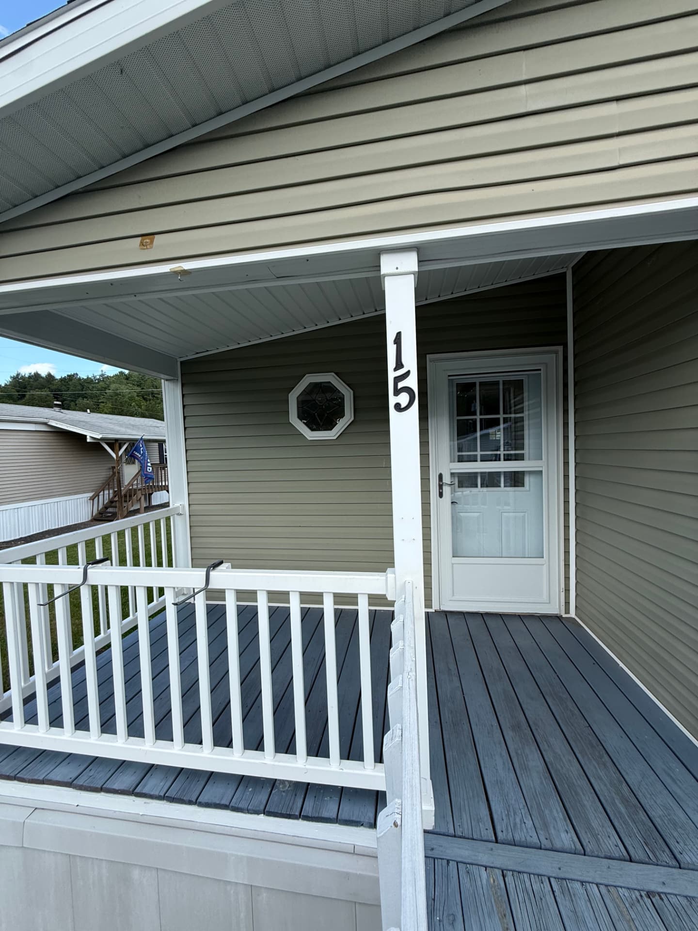 The covered front porch and entry door at 15 Kevin
